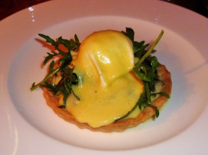 Caramelized red onion tart with pecorino, rocket and poached hens egg